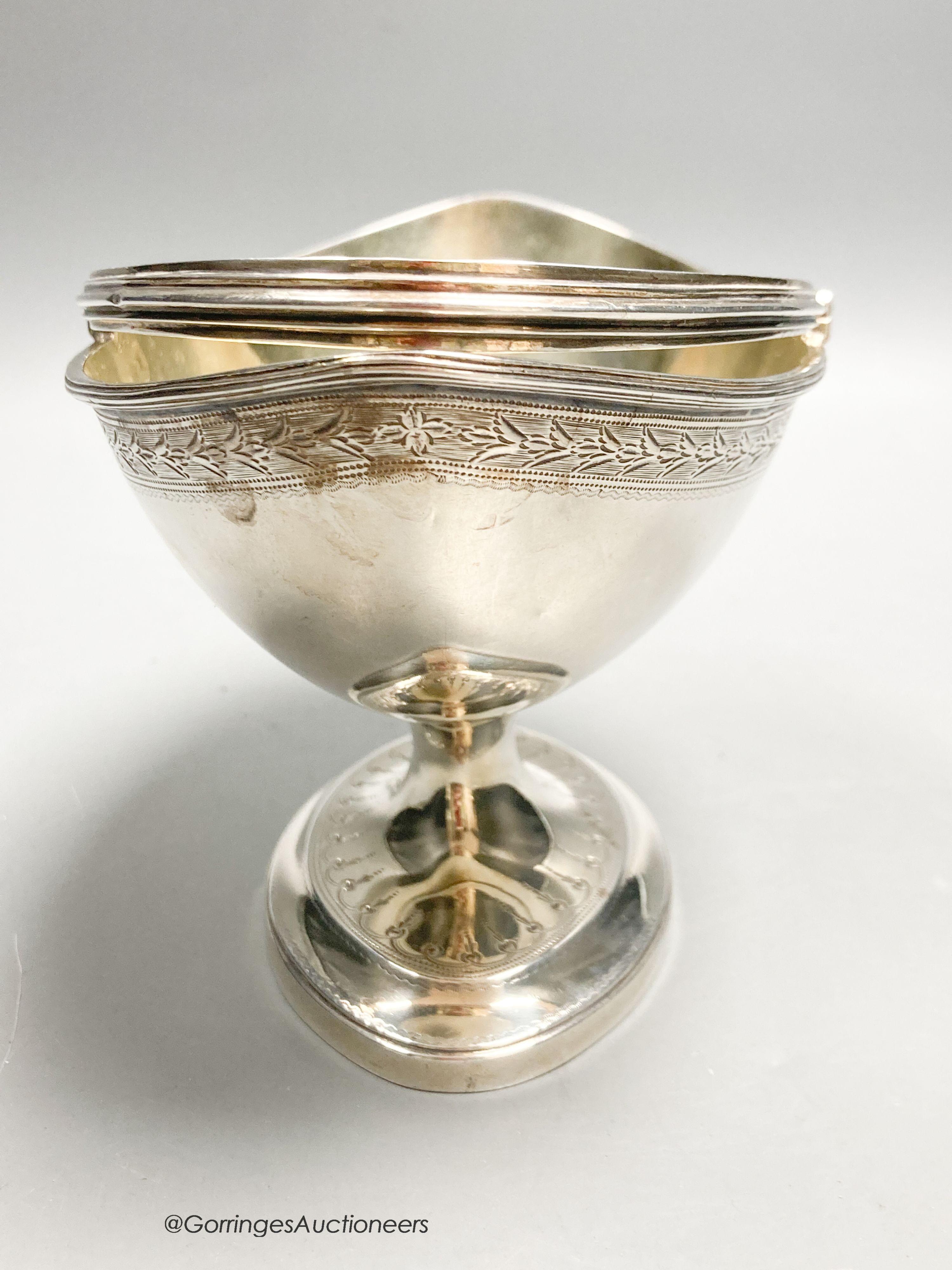A George III silver boat shaped pedestal sugar basket, James Young, London, 1790, width 17.3cm, 10.5oz.